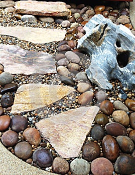 Stone footpath through pebble gravel in rock garden