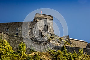 Stone fortress on a hill against a bright blue sky