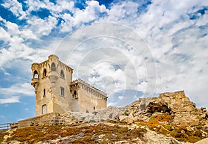 Stone fortress on a hill against a bright blue sky