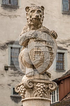 Stone fountain with a bear and a shield photo