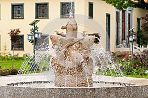 Stone fountain of fishes in traditional chinese park