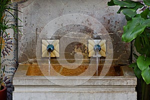 Stone fountain with two water pipes