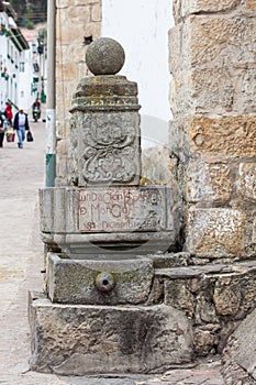 Stone fountain in which you can read the date of the founding of Mongui photo