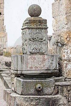 Stone fountain in which you can read the date of the founding of Mongui photo