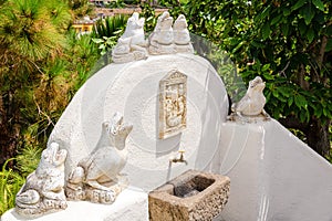 Stone frog statues in a fountain in a landscaped garden. Tenerife, Canary Islands, Spain.