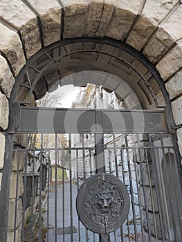 Stone gate with metal door decorated with lion head Belgrade