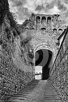 A stone gate, stairs and a narrow street in the city of Massa Maritima