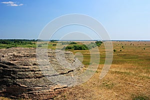 Stone granite rock in the steppe