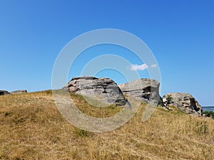 Stone granite rock in the steppe