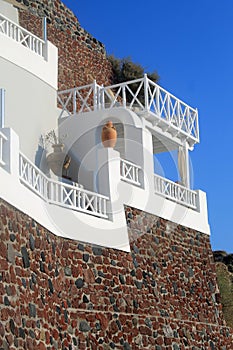 Stone greek house with white balcony, Santorini, Greece