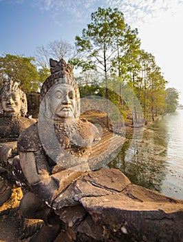 Stone guardians on a bridge at the entrance to a temple in siem reap,cambodia