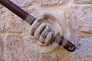 Stone hand holding stairway railing in the Rectors Palace in Dubrovnik, Croatia