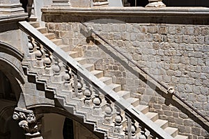 Stone hand holding stairway railing in the Rectors Palace in Dubrovnik, Croatia