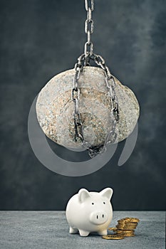 Stone hanging above piggy bank