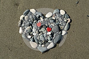 Stone heart on beach sand