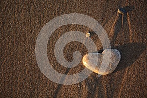 Stone heart on the pebble beach. Love concept. Valentine background