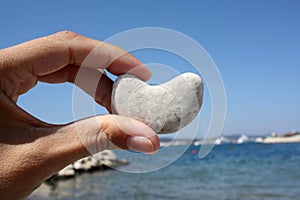 Stone in heart shape in the hand.