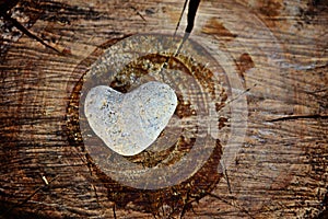 Stone heart shape on wood background