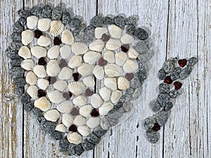 Stone heart wooden background. Heart-shaped sea shells.
