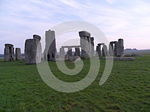 Stone Henge In England Winter Time Tourist in distance