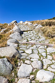 Stone hiking trail to the Laguna Grande de Gredos lake from the Plataforma de Gredos, Spain photo
