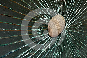 Stone hits and shatters the window glass
