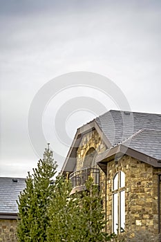 Stone home with half circle balcony and quarter round with extended leg window