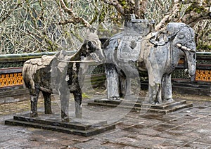 Stone Horse and Elephant sculptures in the forecort preceding the Stele Pavilion in Tu Duc Royal Tomb, Hue, Vietnam