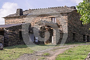 Stone house in the middle of the countryside. Typical house of the black tile villages photo