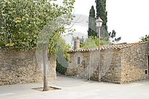 Stone house at plaza of Girona village
