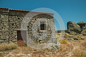 Stone house on rocky hilltop at the Castle of Monsanto