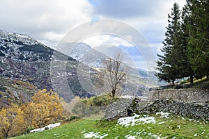 Stone house and snowy mountain of Hervas in autumn, Extremadura photo