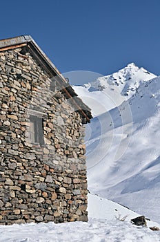 Stone house in Valmeinier mountains in winter skiing area in the French Alps Savoie