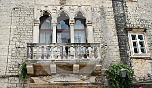 Stone house with windows and balcony in the street of old town, beautiful architecture, sunny day, Trogir, Dalmatia, Croatia