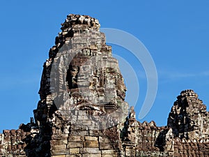 Stone human faces on the towers of the Khmer Bayon Temple