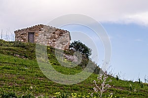 Stone hut on hillside, Sicily, Italy