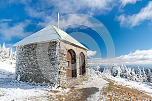 Stone hut / shelter Jeleni studanka in Jeseniky mountains in Czechia during nice winter day with clear sky. Wiew of Czech cottage
