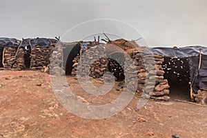 Stone huts at Erta Ale volcano crater rim in Afar depression, Ethiop