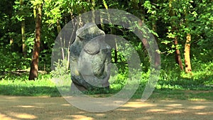 Stone images - Scythian statue. In the woods on a background of trees