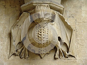 Stone imp carving on wall