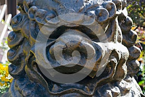 A stone japan dragon face close up in daylight.