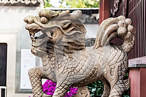 Stone Kylin Qilin statue in chenghuang temple shanghai, China. A mythical hooved chimerical creature known in Chinese and other