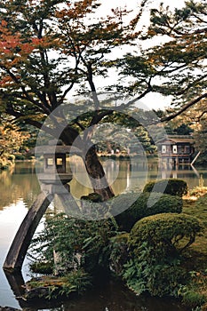 Stone lantern and a lake in the most beautiful garden in Japan Kenrokuen in Kanazawa