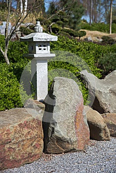 Stone lantern, rock and raked gravel, zen garden landscape design in Japanese style