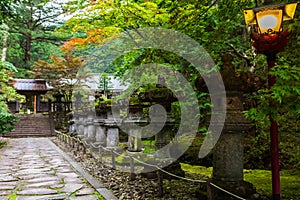 Stone lanterns on pathway in Taiyuin Temple in Nikko, Japan.