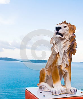 Stone lion ancient statue in sea .