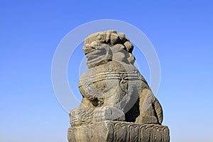 stone lion on bridge railing, China