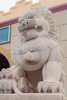 Stone Lion Guardian statue at the entrance gate of Anek Kusala Sala Viharn Sien, Thai-Chinese temple in Pattaya, Thailand. It wa