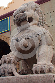 Stone Lion Guardian statue at the entrance gate of Anek Kusala Sala Viharn Sien, Thai-Chinese temple in Pattaya, Thailand. It wa photo