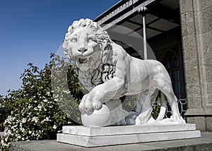 Stone lion in the park of the Vorontsov Palace built in the 19th century near the Crimean mountains